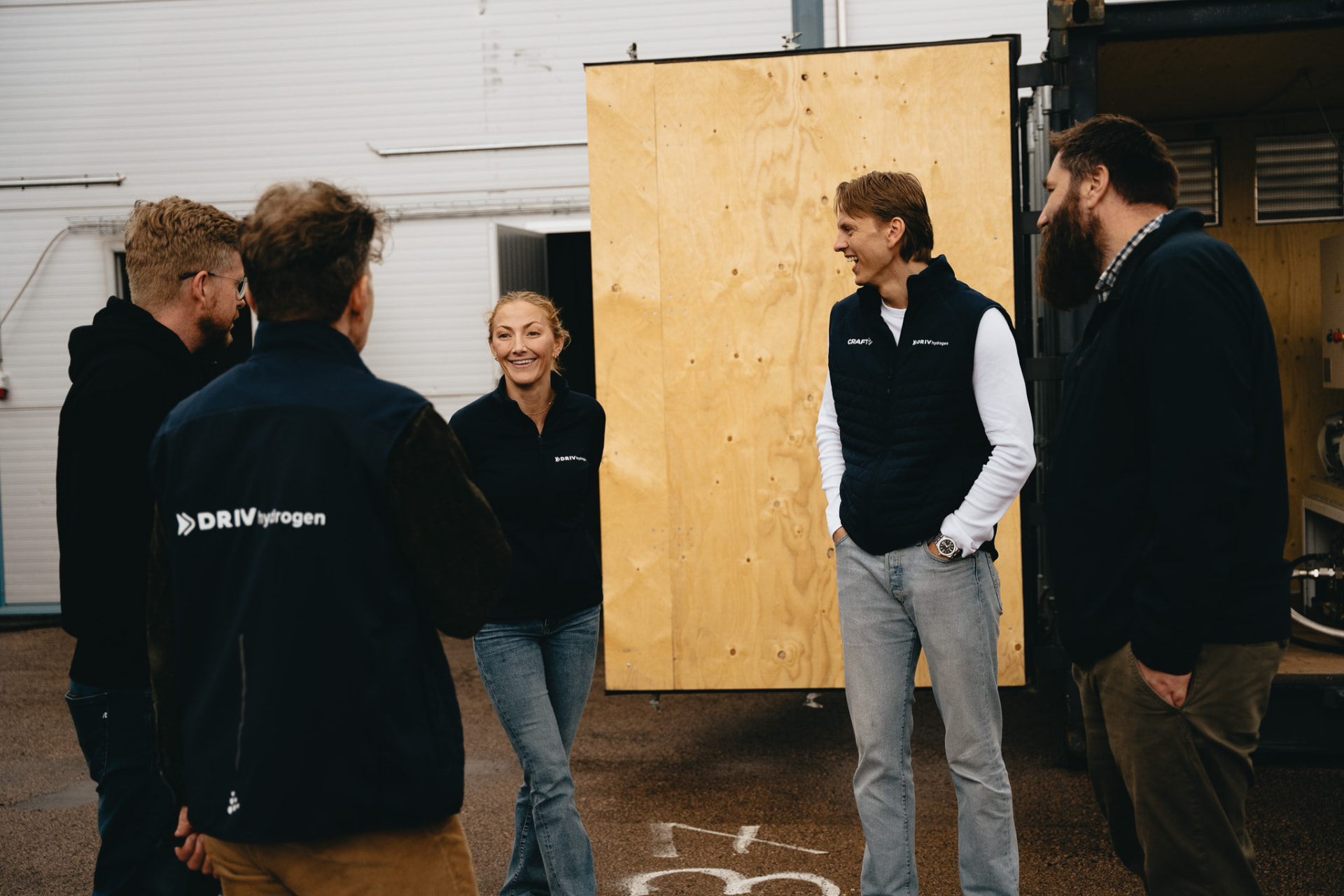 The DRIV hydrogen team in conversation beside a container at the Kløfta facility
